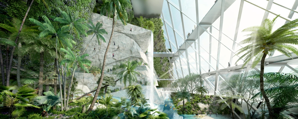 Rock climbers ascend a rocky cliff beside a waterfall in a glass-enclosed tropical conservatory.