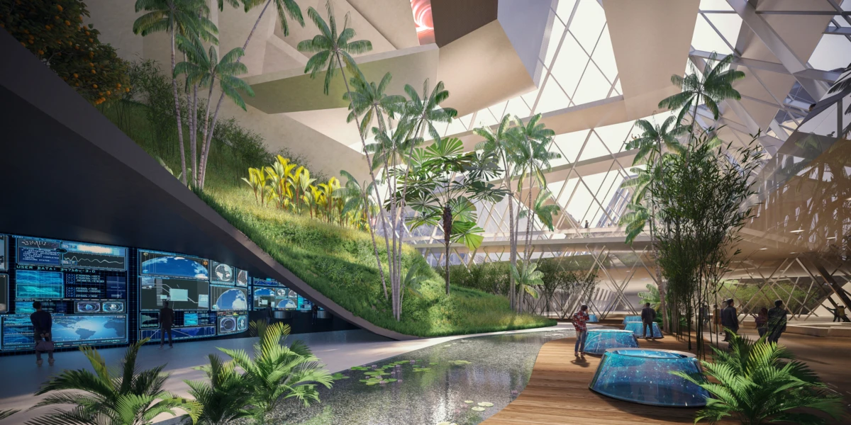 Indoor atrium with tropical plants, curved wooden walkway beside a water feature, and people viewing large digital dashboards along a wall.