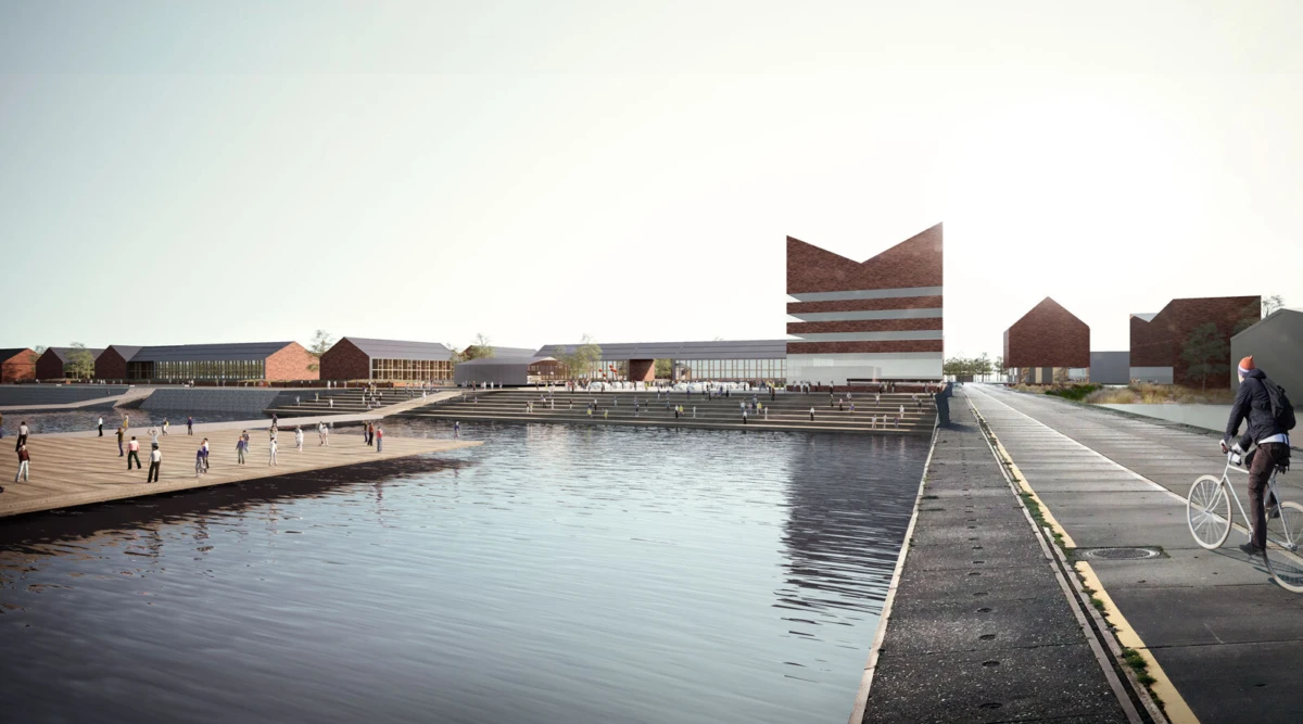 Urban waterfront plaza with stepped terraces and brick buildings; pedestrians walk and a cyclist rides along the riverside path.