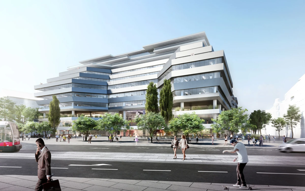 Contemporary glass-office building with tiered, overhanging floors, trees in the plaza, and pedestrians; skateboarder in the foreground.