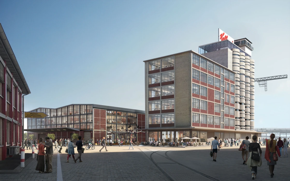 Public square in front of a modern brick-and-glass office complex with outdoor seating and pedestrians; tram tracks run across the foreground.