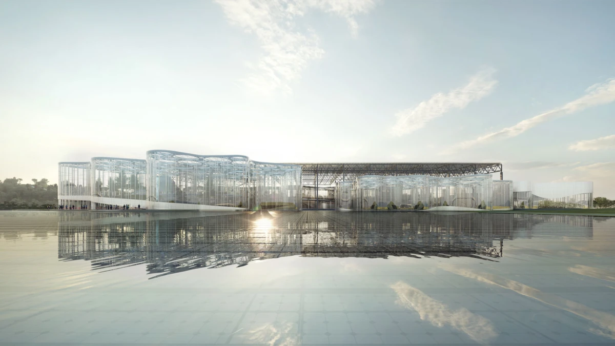 Modern glass architectural complex beside a calm lake, sunrise light reflecting on the water.
