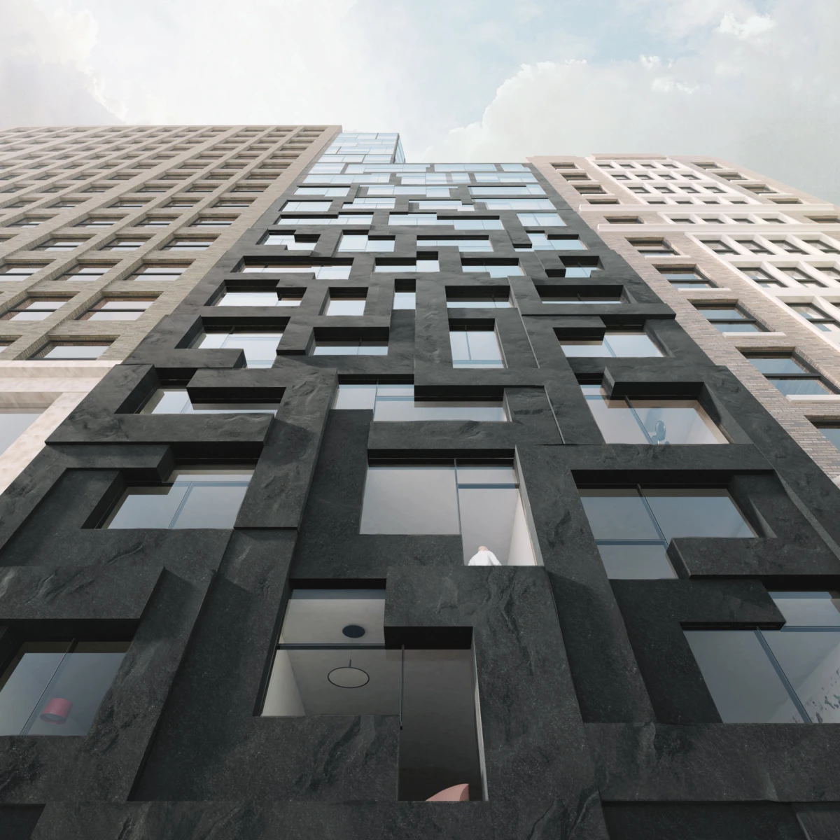 Low-angle view of a black stone high-rise with interlocking rectangular window frames, flanked by lighter buildings, under a cloudy sky.
