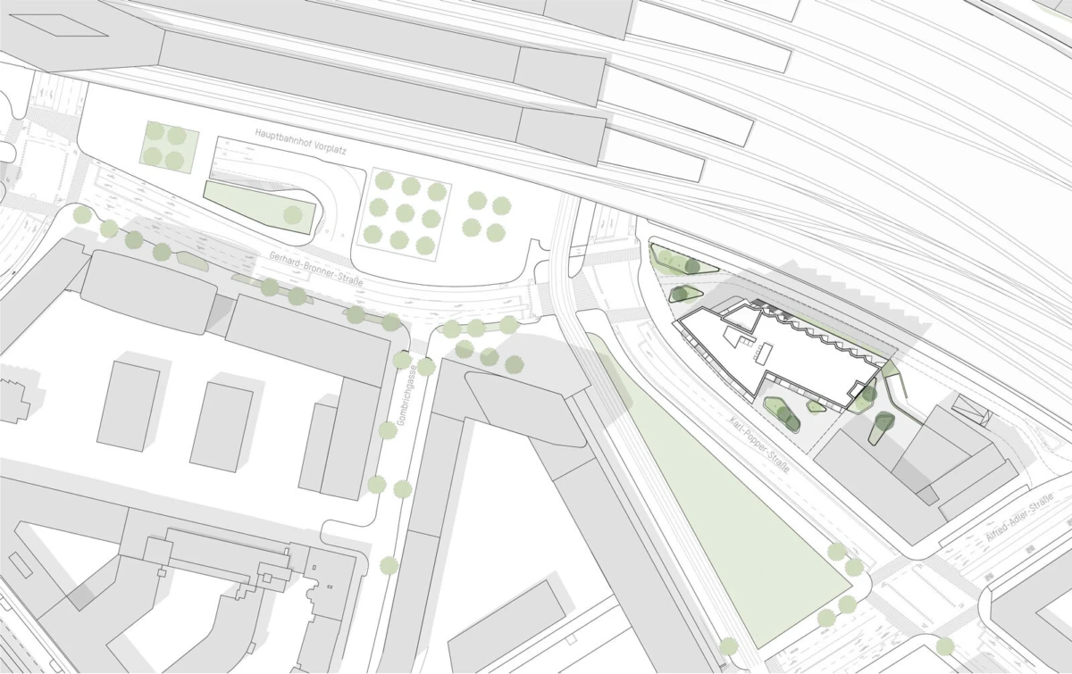Urban site plan showing railway tracks at the top, curved roads, rectangular buildings, and green spaces with trees.