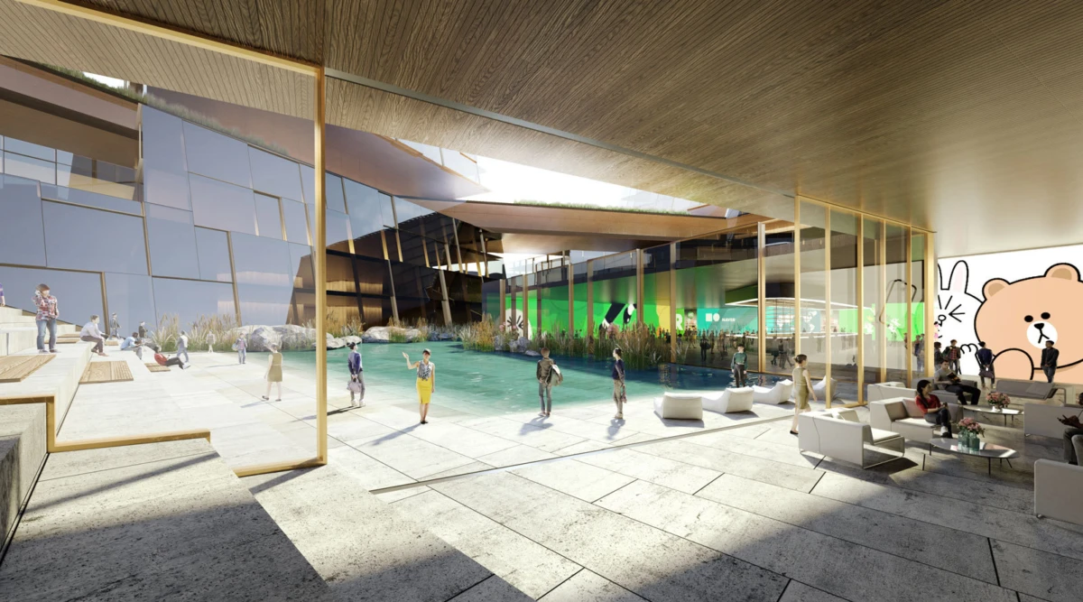 Modern atrium with a central rectangular pool, glass walls, and seating; people walk by as a large cartoon bear mural fills the right wall.