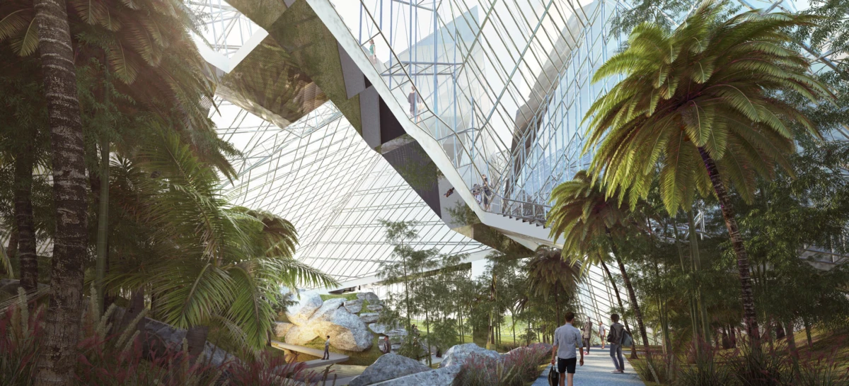 Indoor glass-domed conservatory with tropical palms; visitors stroll along a path beneath a soaring glass atrium.