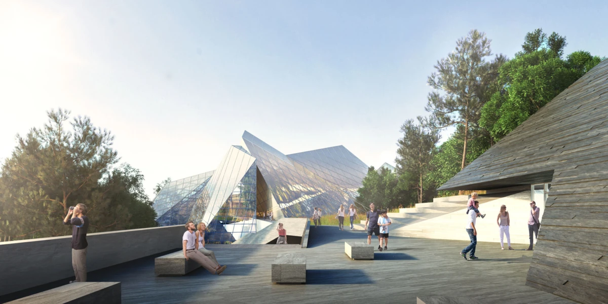 People on a spacious wooden terrace in front of glass pyramid architecture, with a timber-clad building on the right.