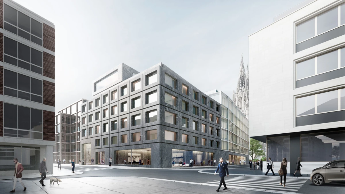Modern gray concrete building with a grid of square windows at a city plaza; pedestrians stroll and cross a zebra crossing, cathedral spire visible.