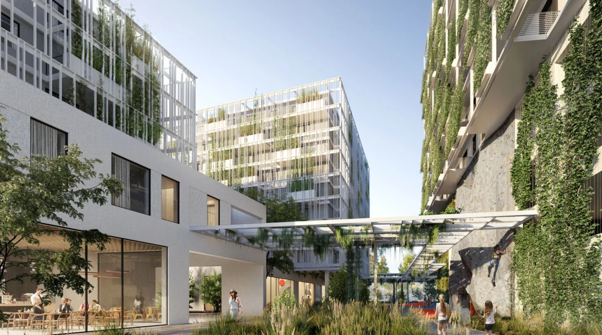 Modern green residential courtyard with glass canopy; people dine at a ground-floor cafe while a climber ascends a rock-climbing wall.