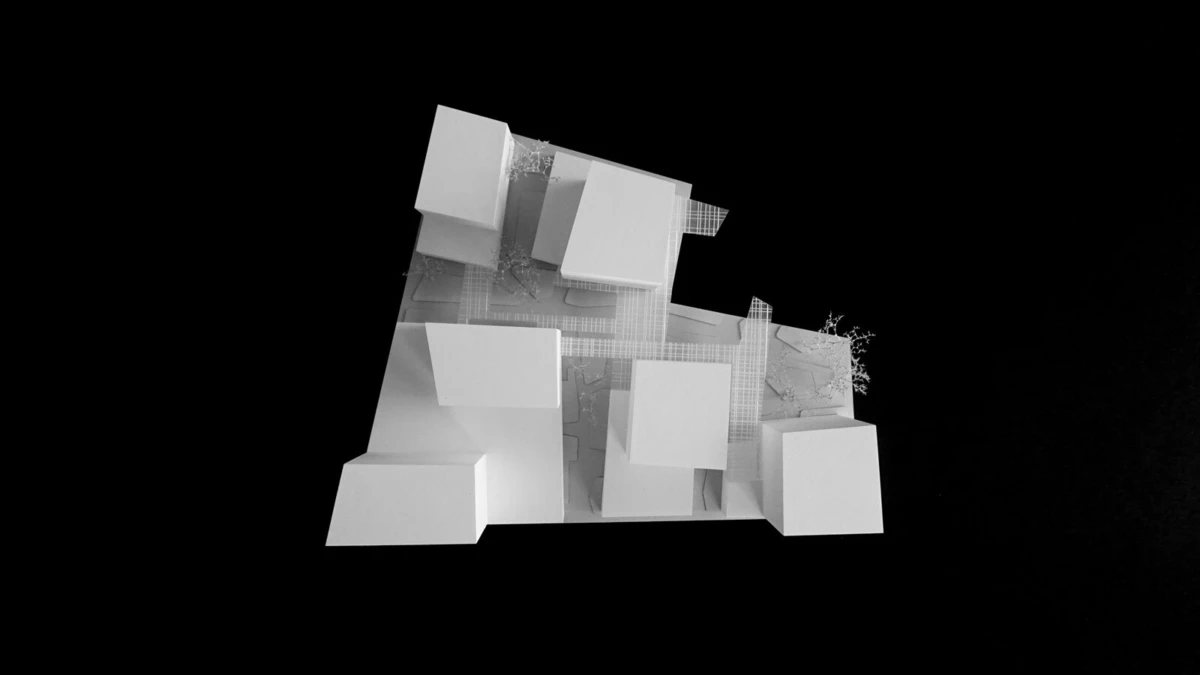 Abstract white blocky architectural model of stacked cubes with a small plant, on a black backdrop.