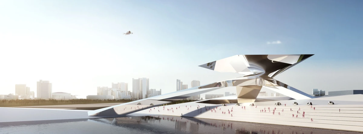 Futuristic angular sculpture on a waterfront plaza; people gather on wide steps, with a city skyline and calm water in the background.