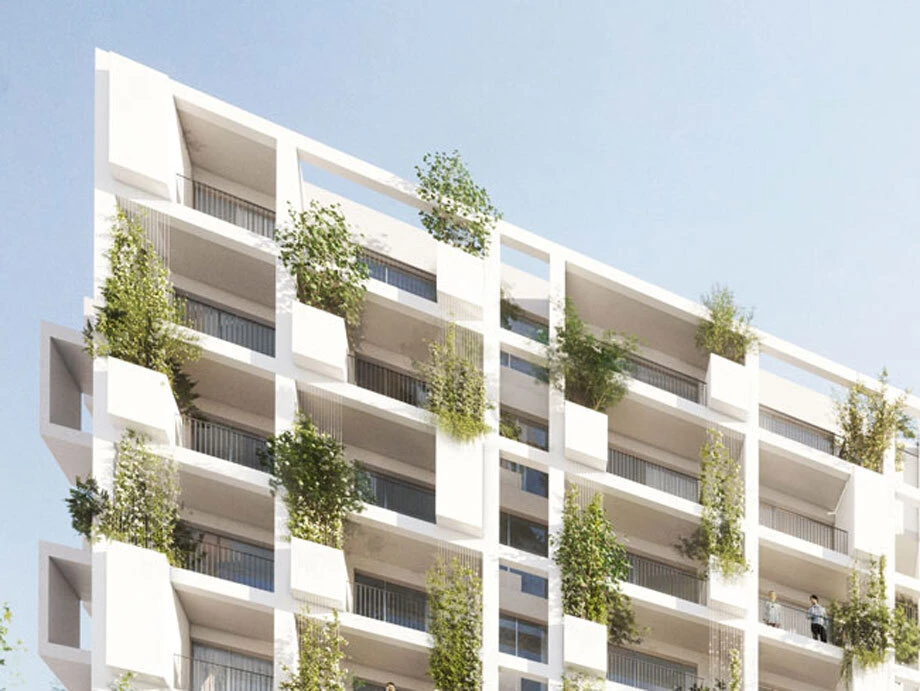 Modern white apartment building with staggered balconies and greenery growing from planters against a blue sky.