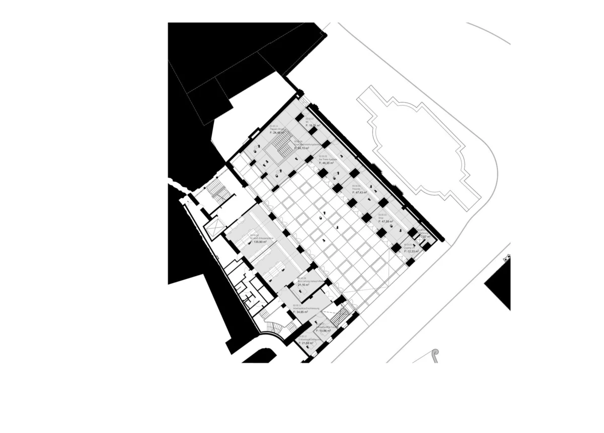 Architectural floor plan of a building, showing a grid of rooms and corridors with an adjacent curved exterior outline.