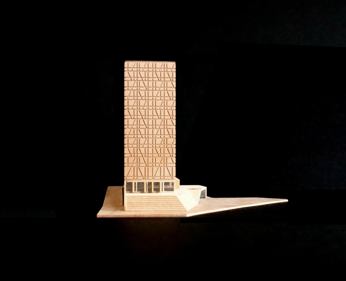 Wooden miniature high-rise tower with diagonal lattice-pattern facade on a stepped base against a black background