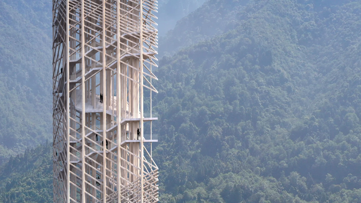 Tall wooden lattice tower with people climbing external staircases, set in a forested mountain valley.