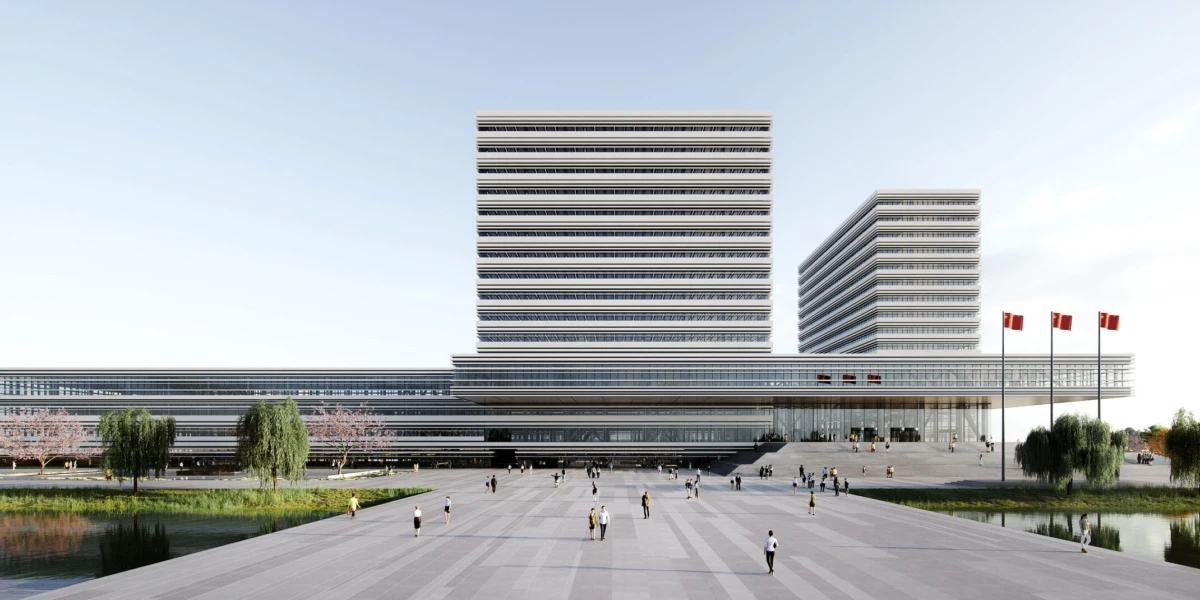 Modern government complex with two tall stacked towers and a long low building; people walk across a wide plaza bounded by ponds and flagpoles.