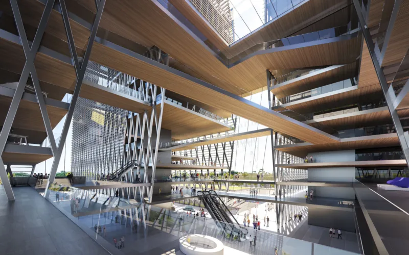 Multi-level modern atrium with escalators, glass floors, and steel beams; visitors move through the open space.