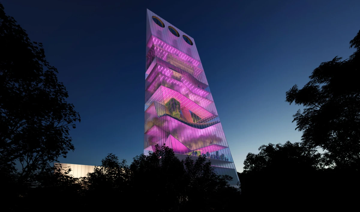 A tall glass-clad tower glowing pink at dusk, surrounded by dark tree silhouettes.