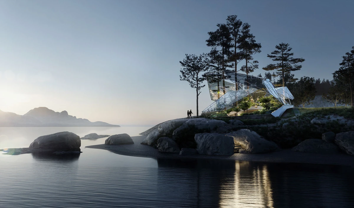 Glass pavilion perched on rocky shore beside calm water at sunset; pine trees surround, a person stands nearby.