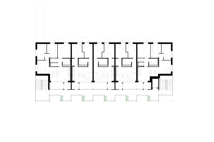 Architectural floor plan of a multi-unit residential building with a central corridor and eight apartments.