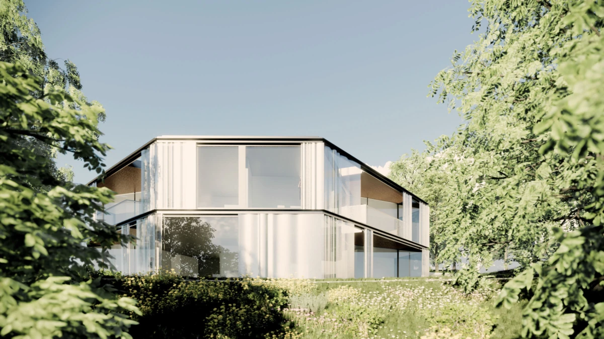 Two-story glass-walled house stands on a grassy slope, framed by trees under a clear blue sky.
