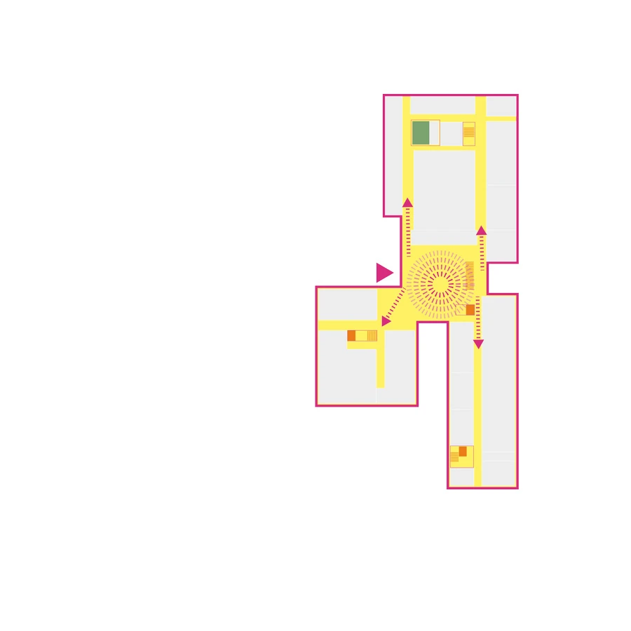 Architectural floor plan with pink outlines, yellow corridors, a central circular atrium with radiating spokes, and arrows indicating circulation.