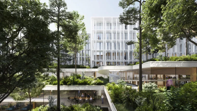 People walk through a lush courtyard of a modern white glass-clad office complex with terraces and trees.