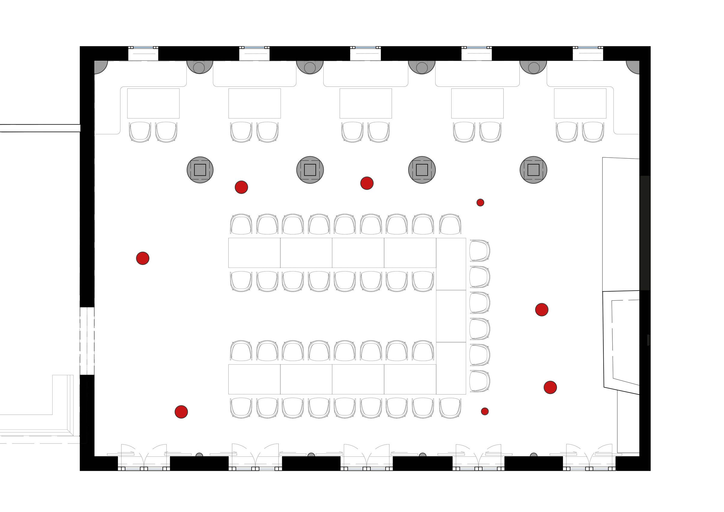 Floor plan of a large meeting room with a central U-shaped table, seating along walls, red floor markers, and doors on left and bottom.