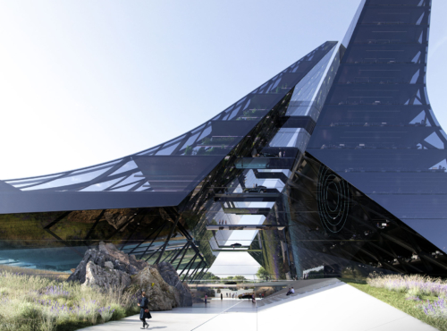 Futuristic glass arch-shaped building with angular, curved surfaces; people walk along a pedestrian path amid lavender landscaping.