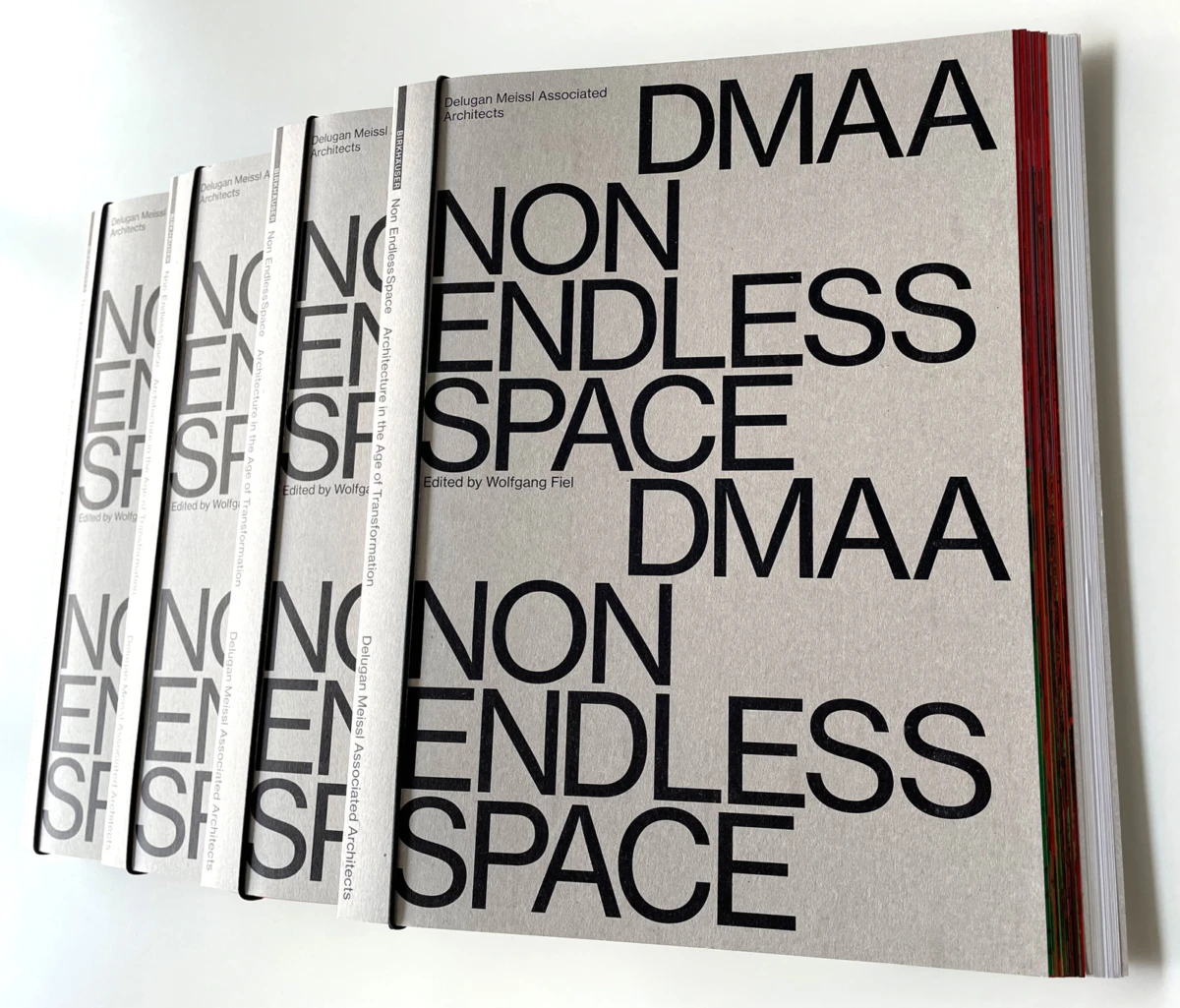 Row of grey design magazines with large bold text reading NON ENDLESS SPACE and DMAA on the covers, fanned on a white surface.