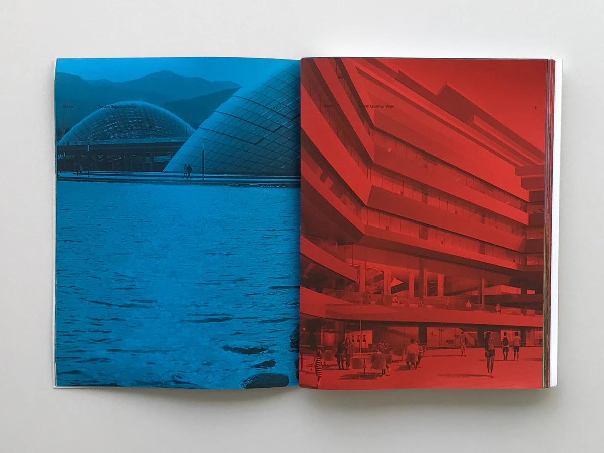 Two-page spread: blue waterfront with a glass-domed pavilion on the left and a red multi-story parking garage on the right.