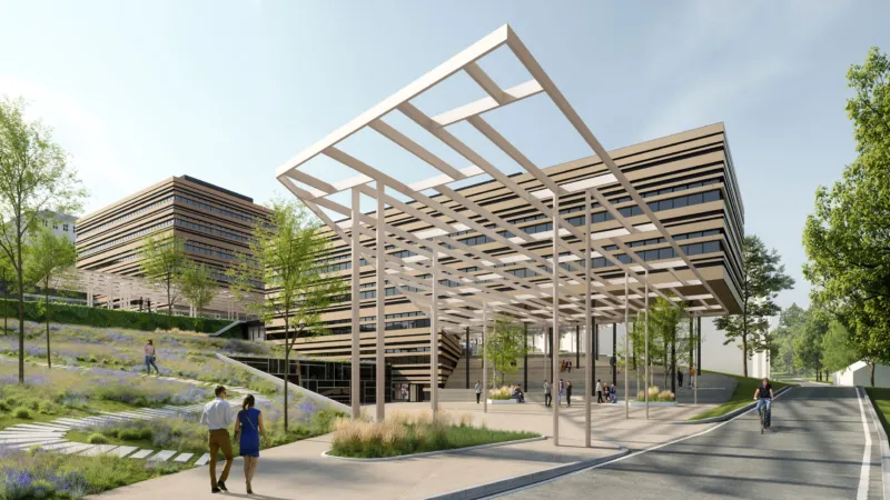 Modern office complex with a white lattice canopy over a plaza; pedestrians stroll amid landscaped slopes and trees.