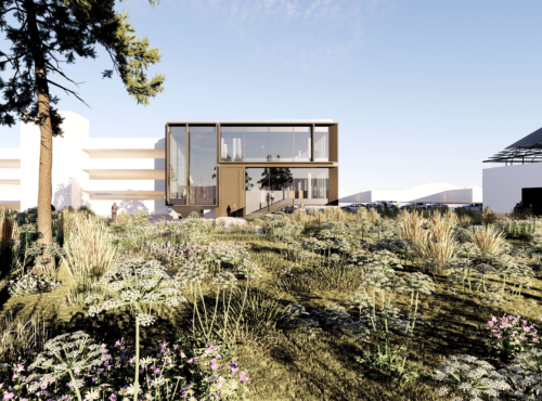 Two-story glass-front building with wooden frame in a sunlit campus, surrounded by native grasses and flowers; a few people near the entrance.