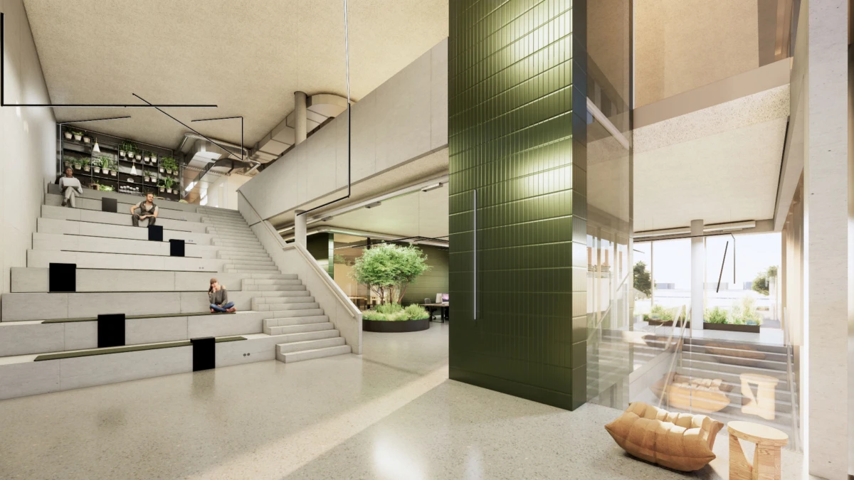 Contemporary lobby atrium with concrete tiered seating, a dark green tiled column, glass walls, and a plant-filled lounge; people sit on the steps.