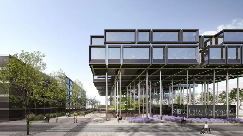 Modern elevated glass-box building on stilts above a pedestrian plaza with trees and lavender; people walk and cycle.
