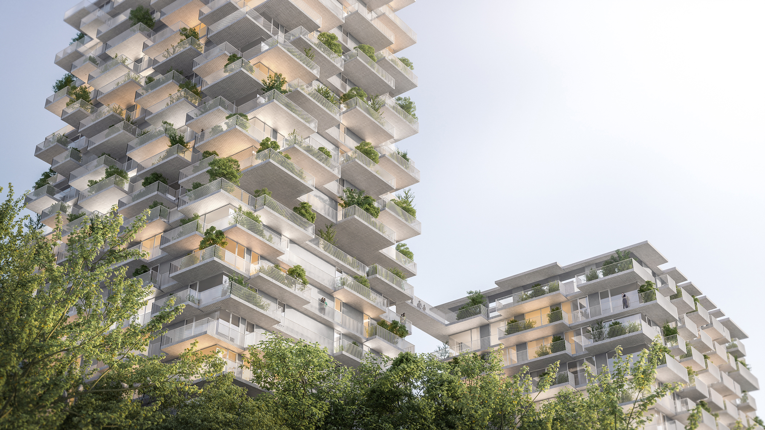 Two modern high-rise residential towers with cascading, plant-filled balconies and a connecting skybridge, set among green trees.