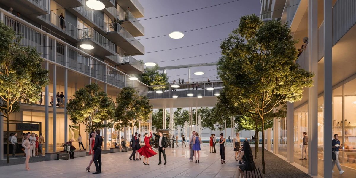 People dancing in a modern glass atrium with trees and upper balconies.