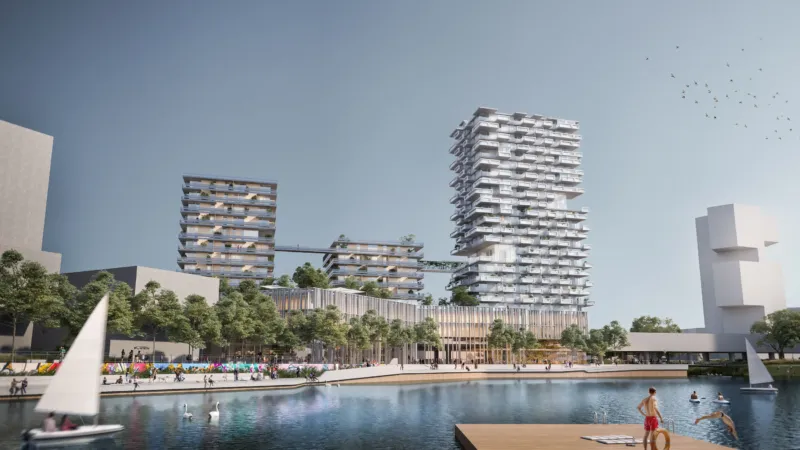 Modern waterfront residential complex with stacked towers, a tree-lined promenade, and people by a calm lake with sailboats.
