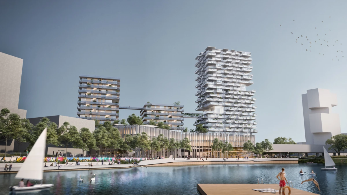 Modern waterfront residential complex with stacked towers, a tree-lined promenade, and people by a calm lake with sailboats.