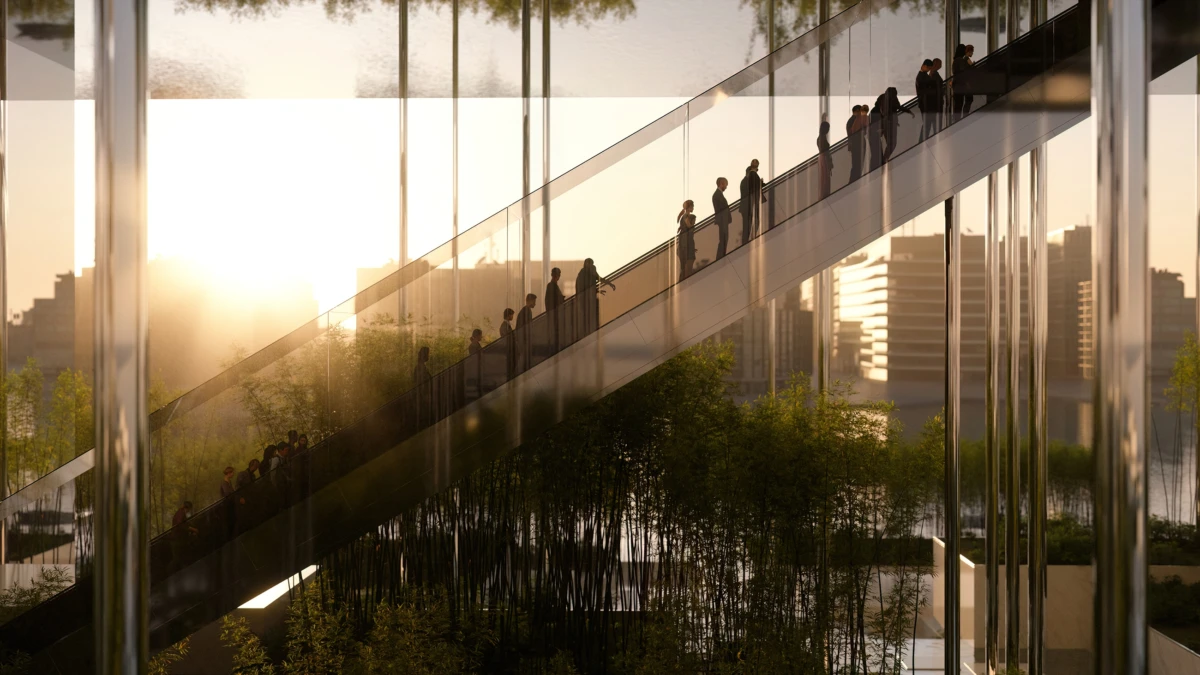 People ascending an escalator inside a glass atrium, with city skyline at sunset and trees below.