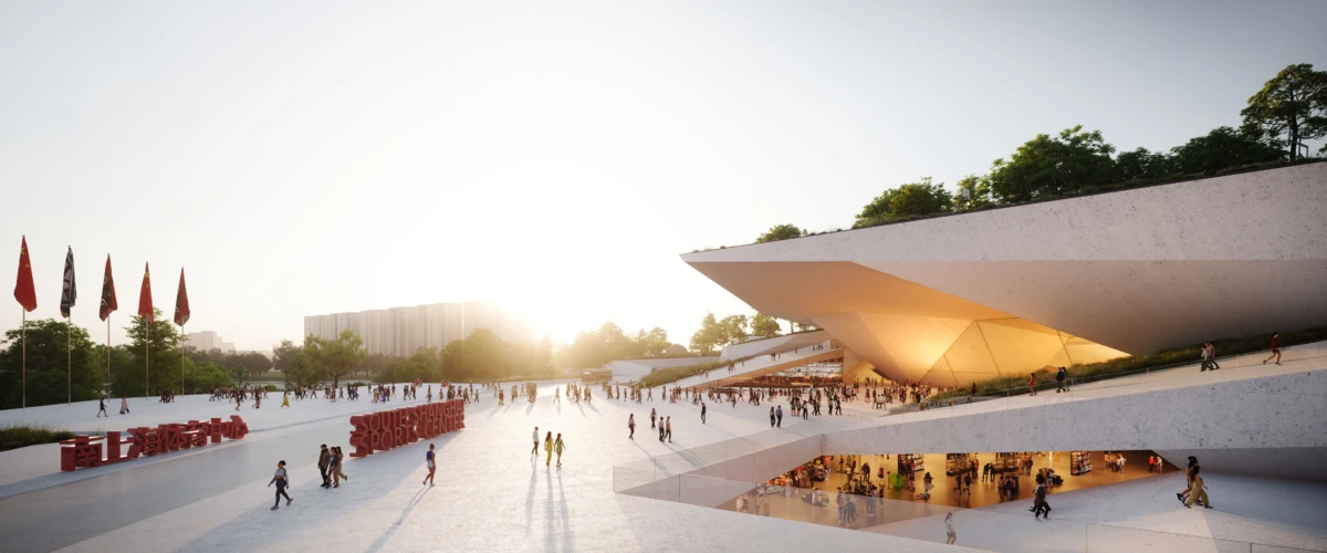 Public plaza in front of a modernist cultural center with a slanted, overhanging roof; people stroll and gather as sunset glows.