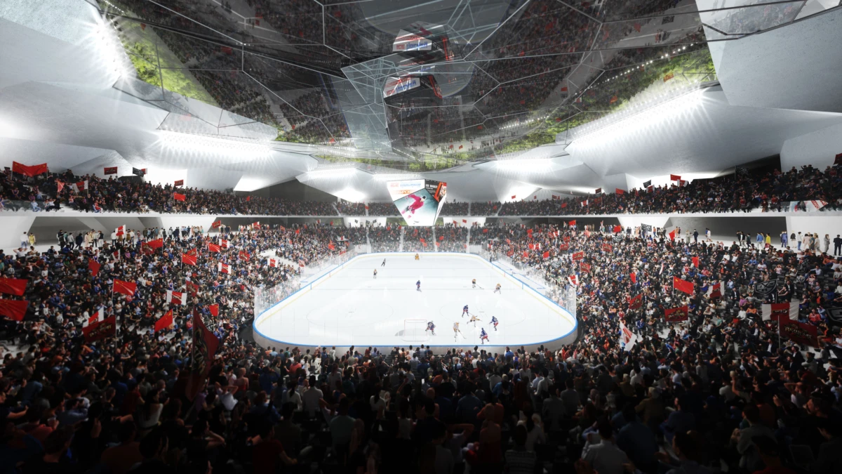 Ice hockey game on a bright rink inside a packed indoor arena with a crowded audience and red banners.