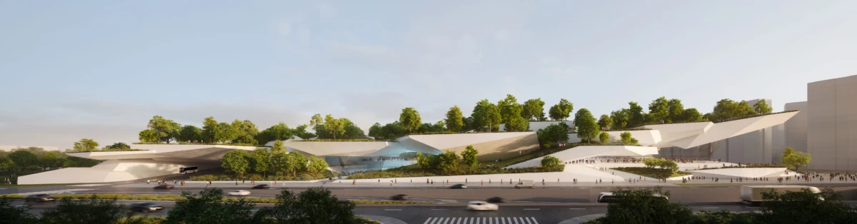 Wide view of a modern white angular building complex with green-roof terraces; trees atop structures, with pedestrians and cars along a street.