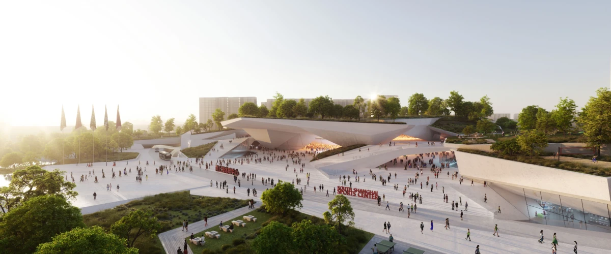 Public plaza at a modern sports center; angular building, crowds on white steps amid trees under a sunlit sky.