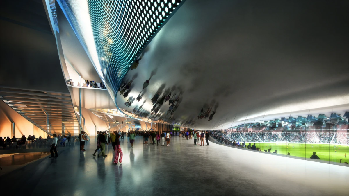 Modern stadium concourse beneath a curved, reflective roof; crowds walk toward a sunlit football pitch visible through glass barriers.