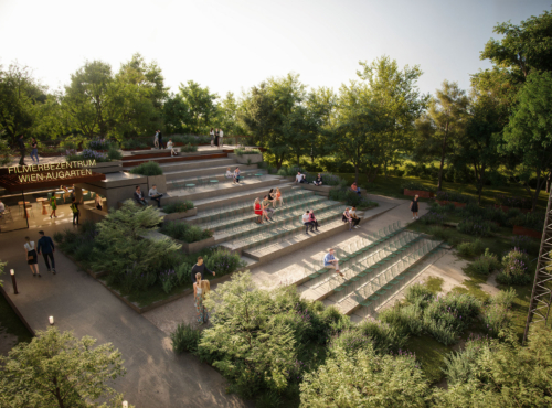 People seated on stepped benches in an outdoor terraced amphitheater in a park, surrounded by trees.