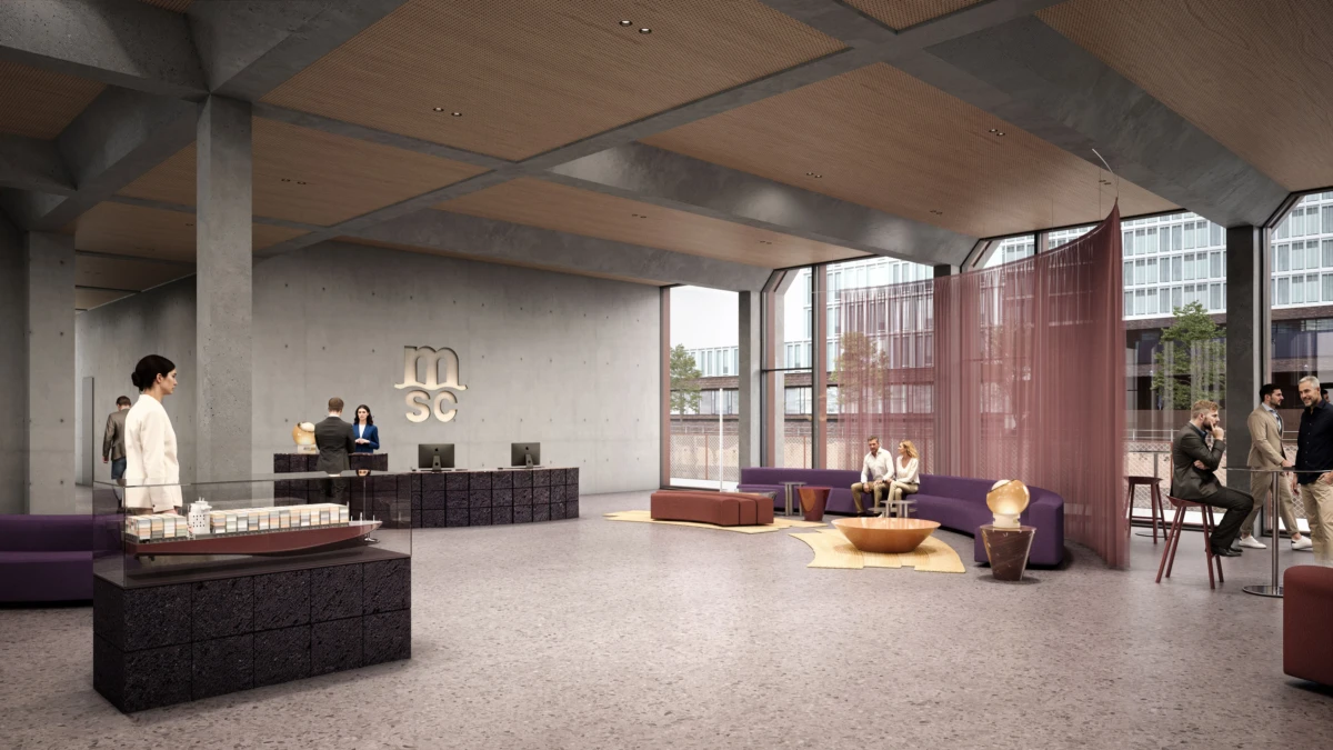Modern office lobby with a reception desk, staff at computers, and purple seating; pink divider by large windows.