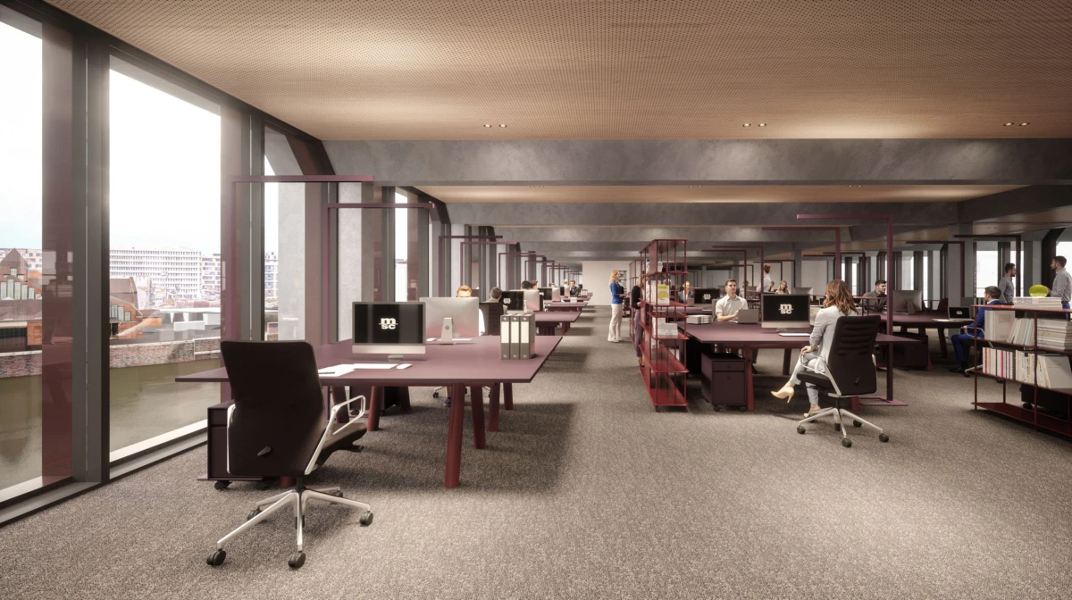 Open-plan office with employees working at maroon desks; floor-to-ceiling windows overlook a city skyline.