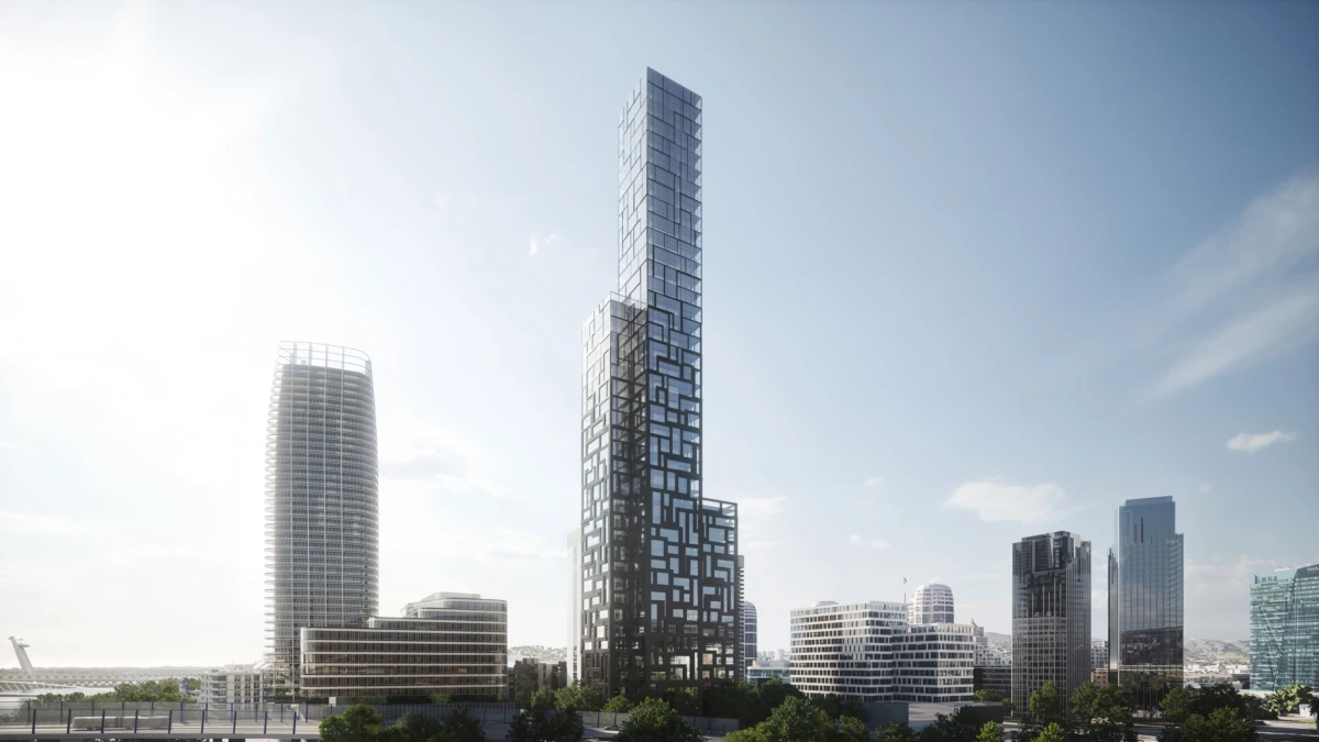 Modern city skyline featuring a tall glass skyscraper with a cube-pattern facade, a rounded high-rise to the left, and other glass towers on a clear day.