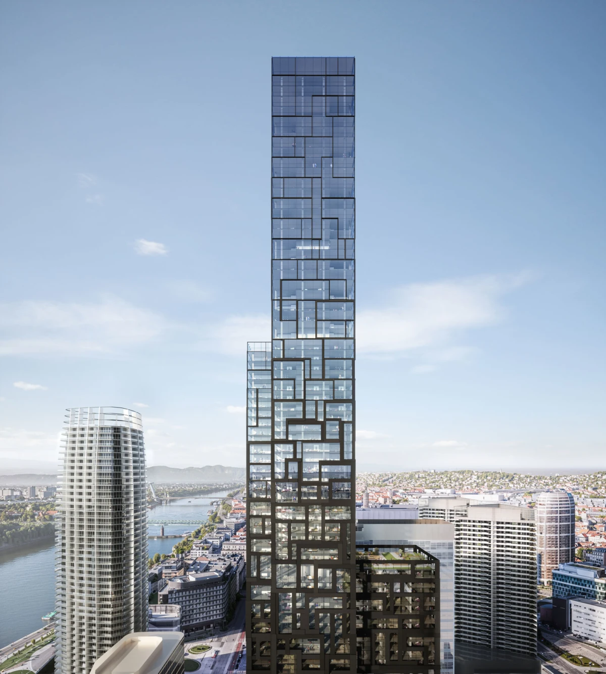 Tall glass skyscraper with a modular, lattice-like façade rises above a city by the river, among other high-rises under a clear blue sky.